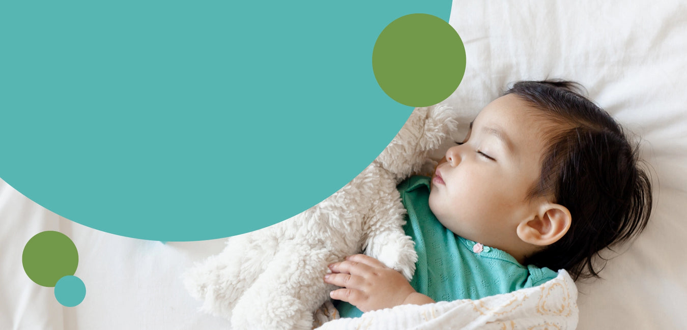 Nurture Naturally, Soothe baby's senses with our Aromatherapy Calming Mist. Photo of baby sleeping with teddy bear and aqua and green graphics.