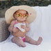 Baby in swimsuit, sunglasses and sun hat holding Non-Toxic, Hypoallergenic Broad Spectrum SPF 30 + Sunscreen