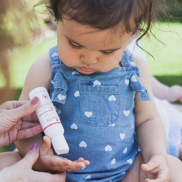 Mom applying Non-Toxic, Hypoallergenic Hand Sanitizer Gel on baby's hand#style_original-scent