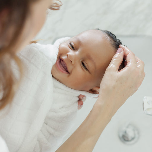 Mom washing baby's hair with Tear-Free, Non-Toxic, Hypoallergenic Shampoo + Body Wash